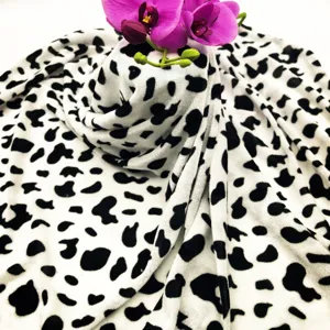 Detail view of black and white animal print fabric for Halloween costume cloak and stage wear.