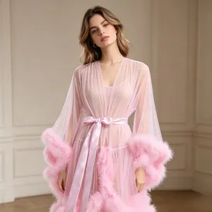 Close-up detail of the pink sheer mesh robe featuring fluffy feather cuffs and tie belt.
