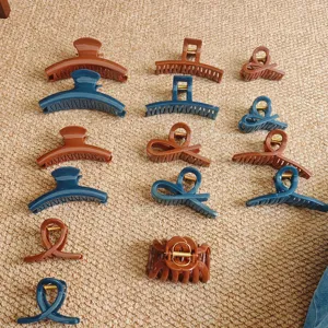 Set of brown and blue hair claw clips in various geometric and elegant shapes for thick hair.
