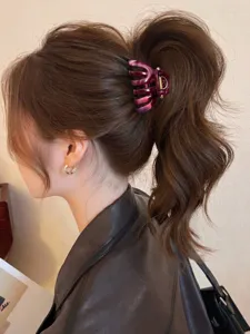 Detailed view of the stylish gradient triangular hair claw clip worn in a high ponytail.