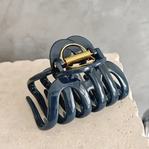 Large dark blue hair claw clip for thick hair, stylish aesthetic resin styling accessory.