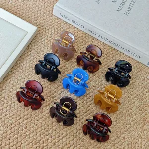 Set of multi-color mini hair claw clips for styling chic updos, elegant hair accessory detail.