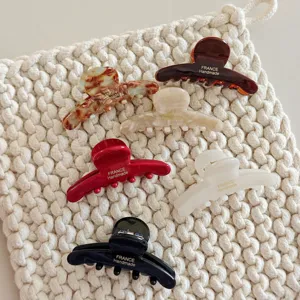 Detailed close-up of premium acetate hair claws showcasing exquisite textures and vivid colors.