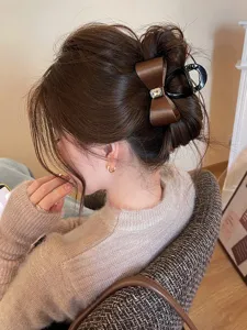 Brown satin bow hair claw clip with crystal rhinestones for elegant updo hairstyles.