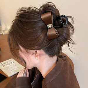 Brown satin bow hair claw clip with rhinestone, elegant shark clip for women and girls' styling.