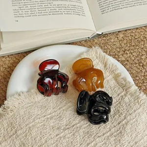Set of three stylish mini hair claw clips in tortoiseshell, amber and black for daily wear.