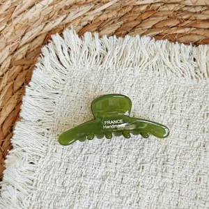 Green acetate hair claw detail showing elegant design and smooth texture for daily styling.
