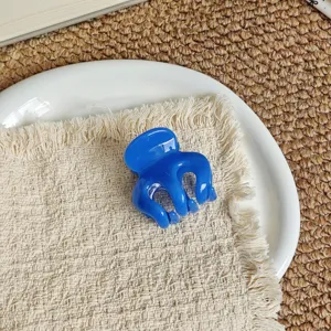 Vibrant blue hair claw clip for elegant daily hairstyles, stylish compact hair accessory.