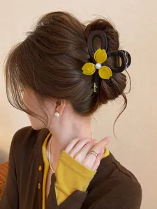 Elegant floral pearl hair claw clip for women, stylish brown and yellow updo shark clip.