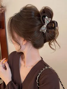 Elegant bow hair claw clip with abalone texture for women elegant updo daily styling.