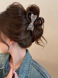 Large bow hair claw clip for women, stylish iridescent hair accessory for elegant updo hairstyles.