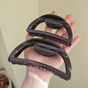 Large semi-circular hair claw clip for women, thick resin shark clip for back hair styling.