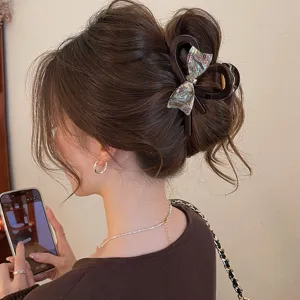 Elegant hair claw clip with colorful bow design, stylish large shark clip for women hair styling.