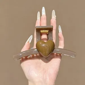 Brown hair claw clip detail view, glossy heart design hair accessory for daily styling.