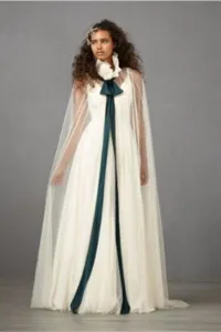 Transparante tulle bruidscape met hoge geplooide kraag en donkergroene strik trouwjurk accessoire.