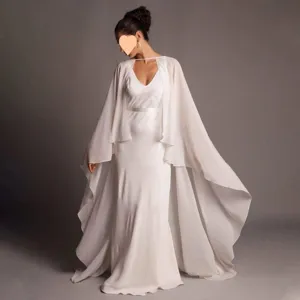 Elegant chiffon bridal cape detail shot, flowing long white wedding cloak for women.