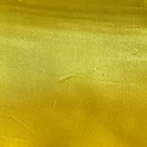 Yellow satin fabric detail close-up texture textile material for costume making