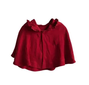 Kids red knitted cape detail, cute ruffle collar winter cloak, soft festive children warm shawl.