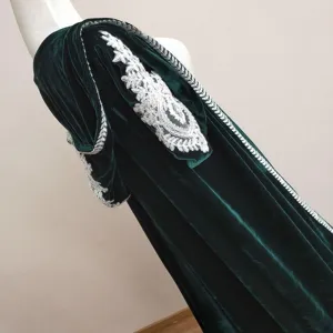 Detailed view of dark green velvet hooded cape with silver embroidery trim for costume wear.