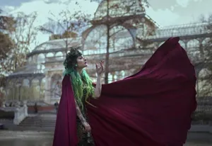 Stunning red hooded cloak detail, elegant flowing cape for photography and holiday events.