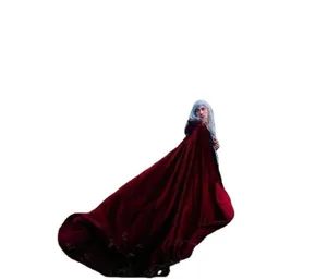 Detailed view of the dark red velvet cloak, showing vintage hemline drape and texture.