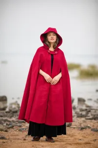 Detail view of women red hooded wool cloak, warm winter cape with raglan sleeves.