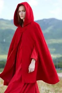 Red hooded cloak detail, warm wool blend fabric, winter cape fashion style outfit.