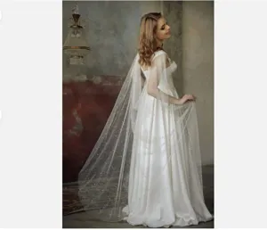 Bride long white ivory mesh cape with pearls, elegant sheer wedding cloak detail.