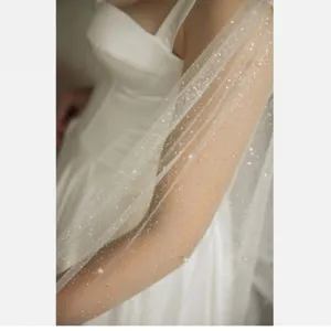 Elegant bridal cape with sparkling tulle and pearl accents, perfect for wedding dress match.