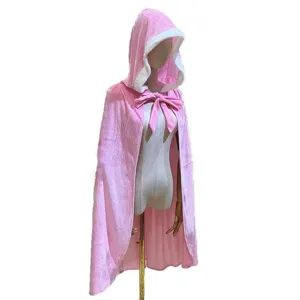 Detail shot of the pink hooded cape with white faux fur trim and bow tie decoration.