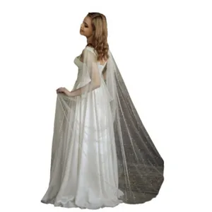 Stunning bridal wedding cape in ivory white with delicate pearls and sparkling glitter mesh design.
