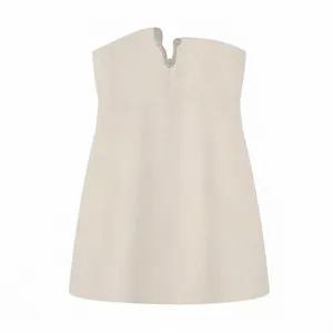 Close-up detail of the elegant beige sleeveless short dress with rhinestone V-neck design.