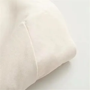 Detailed view of the elegant sleeveless dress fabric, smooth texture, solid color style.
