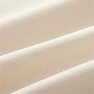 Detailed view of smooth solid color fabric showing fine texture and elegant folds for dress.