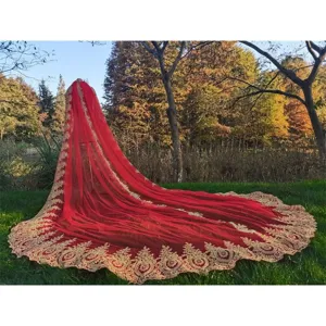 Main image of a stunning red cathedral wedding veil cloak with luxurious gold lace embroidery.