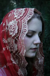 Exquisite red mesh embroidered lace veil detail shot, elegant floral pattern for women headwear.
