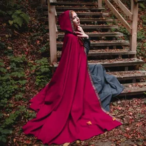 Detailed view of the medieval hooded cape, featuring elegant retro trim and rich red fabric.