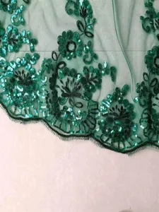 Green sequin lace trim embroidery detail close up, elegant mesh fabric for bridal veils.