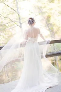 Detail shot of a long bridal veil with comb cut edge, elegant white wedding accessory for women.