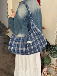 Detail view of Korean style retro plaid pleated canvas tote bag, casual shoulder bag design.