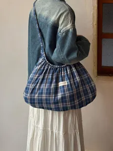 Blue plaid canvas shoulder bag detail view, casual hobo tote style with soft pleated design for daily wear.