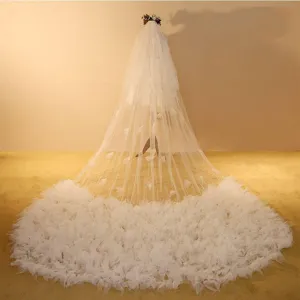 Long wedding veil with stunning floral train, elegant white mesh bridal hair accessory for special days.