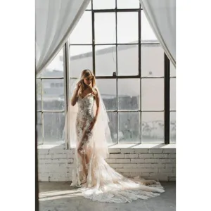 Elegant bridal lace wedding dress and sheer veil set, perfect for romantic photography.