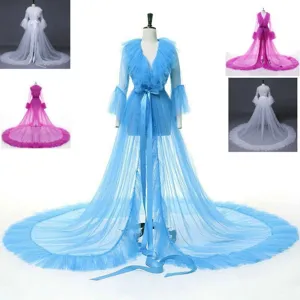 Details of tulle bridal cape with long sleeves, flowing train and delicate mesh fabric options.