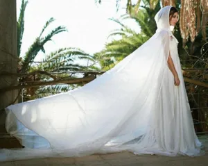 Elegant white hooded cape detail showing flowing chiffon fabric and dramatic long train.