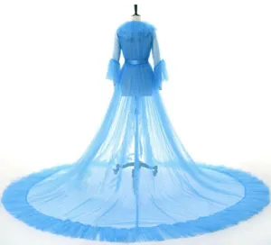 Detail view of blue tulle bridal cape cloak with long train and sleeves, elegant wedding accessory.
