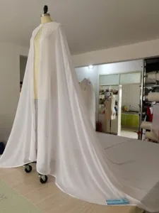 White chiffon long flowing cape cloak for women elegant stage photography details.