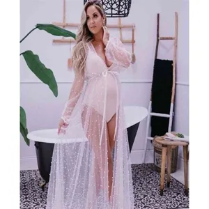 Sheer long maternity cloak detail showing delicate pearl embellishments and soft mesh fabric.