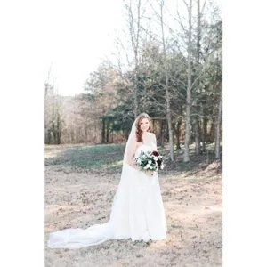 Double layer long trailing wedding veil in white, elegant bridal hair accessory for photography.