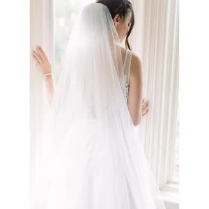Exquisite white double layer long bridal veil for elegant wedding and photography.
